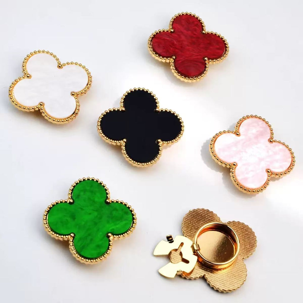 Four-leaf clover charm rings in multiple colors with gold beaded border