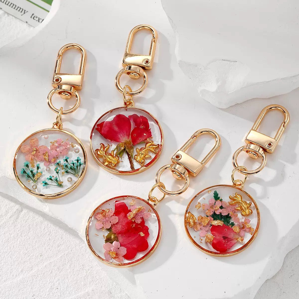 Dried flower resin keychains with gold-tone frames